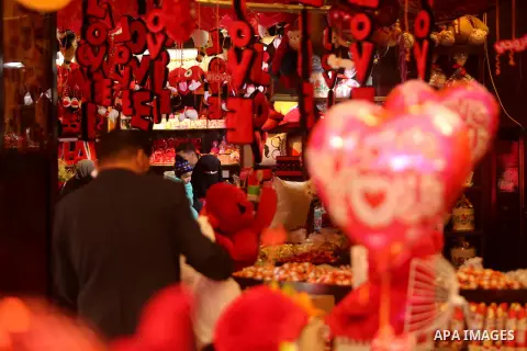 Palestinian vendors display flowers, red teddy bears, red ballons and pillows on Valentine's day in Gaza city on February 14, 2017. Valentine's Day is increasingly popular in the region as people have taken up the custom...