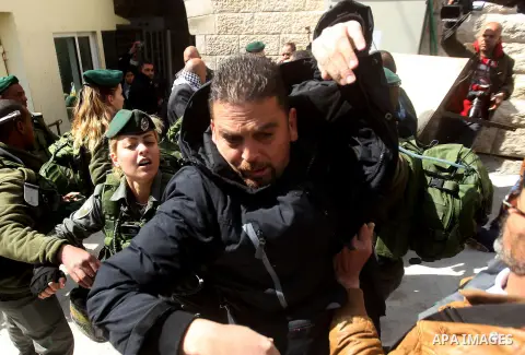 Israeli security forces scuffles with Palestinian protesters during a protest after Friday prayers outside the Ibrahimi mosque calling for the removal of settlers and reopening of a closed street in the West Bank town of...