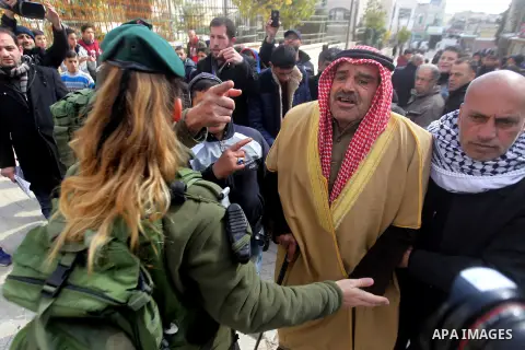 Israeli security forces scuffles with Palestinian protesters during a protest after Friday prayers outside the Ibrahimi mosque calling for the removal of settlers and reopening of a closed street in the West Bank town of...
