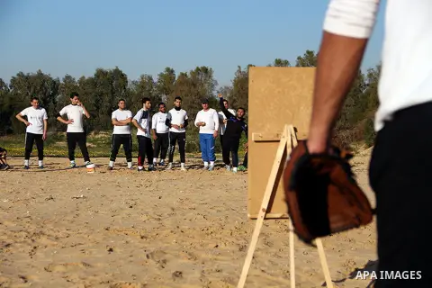 Palestinian youths take part in Baseball training, in southern Gaza strip, on February 20, 2017. Baseball is a bat-and-ball game played between two teams of nine players each, who take turns batting and fielding. Basebal...