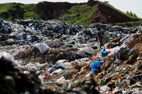 A Palestinian man collects plastics and metals from a pile of waste in Gaza city, February 22, 2017. Workers collect the household recyclables, metals and plastic from landfill and garbage to sell to the local factories....
