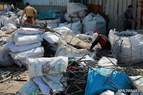A Palestinian worker reuses plastics and metals to produce water hoses at a factory, in Gaza city, February 22, 2017. Workers collect the household recyclables, metals and plastic from landfill and garbage to sell to the...