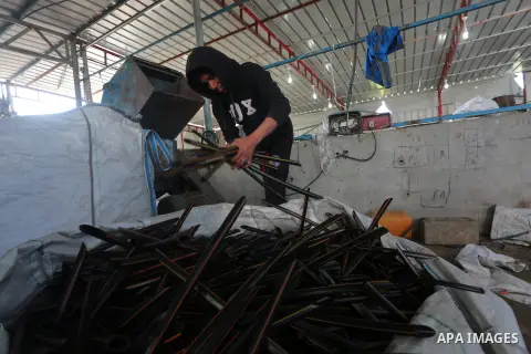 A Palestinian worker reuses plastics and metals to produce water hoses at a factory, in Gaza city, February 22, 2017. Workers collect the household recyclables, metals and plastic from landfill and garbage to sell to the...