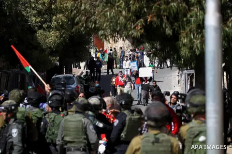 Palestinian and foreign protesters demonstrate, calling for the opening of Shuhada Street, which is largely closed off to Palestinians, in the West Bank city of Hebron, coinciding with the anniversary of a 1994 massacre...