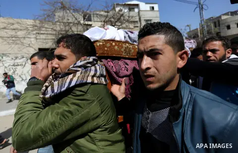 Palestinians carry the body of Palestinian Abdullah Alnamula, 23, who died after inhaling toxic gas inside the tunnel along the border between the Gaza Strip and Egypt during his funeral in Rafah in the southern Gaza str...