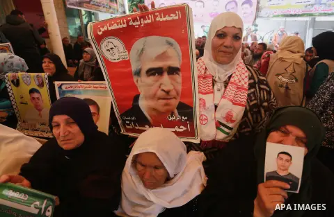 Palestinians hold placards during a protest to show solidarity with Palestinian prisoners held in Israeli Jails, in front of Red cross office in Gaza city, on February 27, 2017. Photo by Mohammed Asad