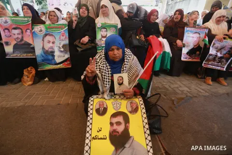 Palestinians hold placards during a protest to show solidarity with Palestinian prisoners held in Israeli Jails, in front of Red cross office in Gaza city, on February 27, 2017. Photo by Mohammed Asad