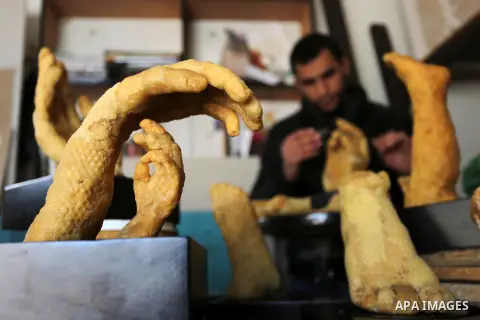 Palestinian artist, Mohammed Abu Hashish, 29, uses beeswax to produce models of human limb, at his workshop, in the al-Maghazi refugee camp, in the centre of the Gaza Strip, on February 27, 2017. Photo by Ashraf Amra
