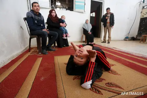 Wael Gharbaoui, a 6-year-old Palestinian boy, demonstrates acrobatics skills at his house in Jabalia refugee camp in the northern Gaza Strip, on March 01, 2017. Photo by Mohammed Asad