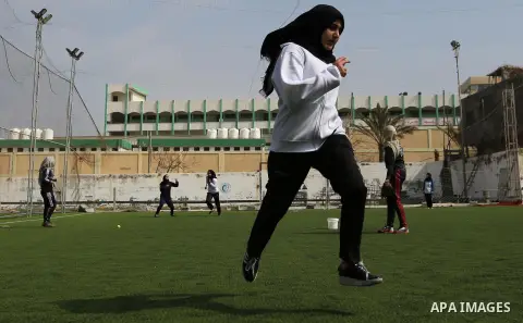 A Palestinian girl takes part in Baseball training, in Gaza city, on February 20, 2017. Baseball is a bat-and-ball game played between two teams of nine players each, who take turns batting and fielding. Baseball is thou...