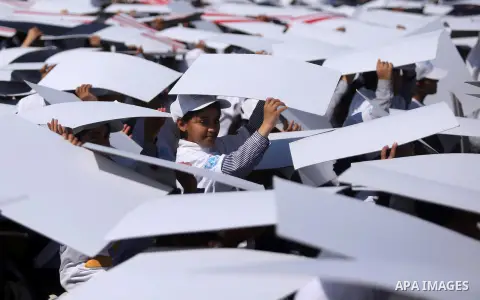 Palestinian schoolgirls fly kites to show solidarity with the Japanese people during an event organised by the United Nations Relief and Works Agency (UNRWA) to mark the the sixth anniversary of the Tohoku earthquake and...