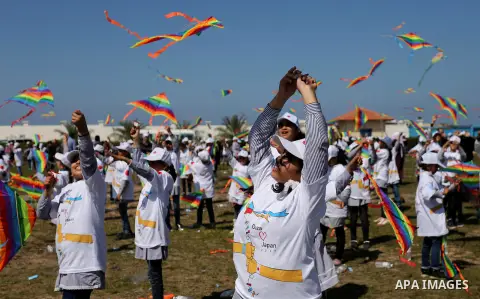 Palestinian schoolgirls fly kites to show solidarity with the Japanese people during an event organised by the United Nations Relief and Works Agency (UNRWA) to mark the the sixth anniversary of the Tohoku earthquake and...