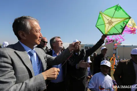 Bo Schack, director of United Nations Relief and Works Agency operations in Gaza, and Japanese ambassador Takeshi Okubo fly kites during an event organised by the United Nations Relief and Works Agency (UNRWA) to mark th...