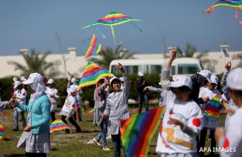 Palestinian schoolgirls fly kites to show solidarity with the Japanese people during an event organised by the United Nations Relief and Works Agency (UNRWA) to mark the the sixth anniversary of the Tohoku earthquake and...