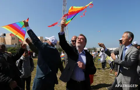 Bo Schack, director of United Nations Relief and Works Agency operations in Gaza, and Japanese ambassador Takeshi Okubo fly kites during an event organised by the United Nations Relief and Works Agency (UNRWA) to mark th...