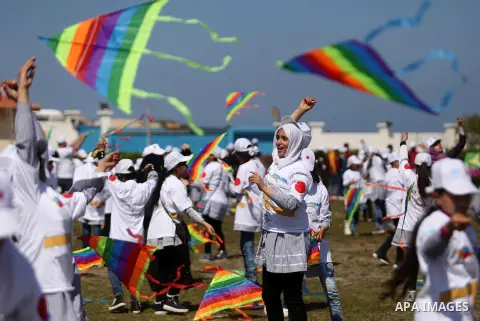 Palestinian schoolgirls fly kites to show solidarity with the Japanese people during an event organised by the United Nations Relief and Works Agency (UNRWA) to mark the the sixth anniversary of the Tohoku earthquake and...