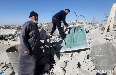 Palestinians remove belongings from rubble of a house after it was demolished by the Israeli army as it did not have an Israeli-issued construction permit, in the West Bank city of Hebron March 6, 2017. Photo by Wisam Ha...