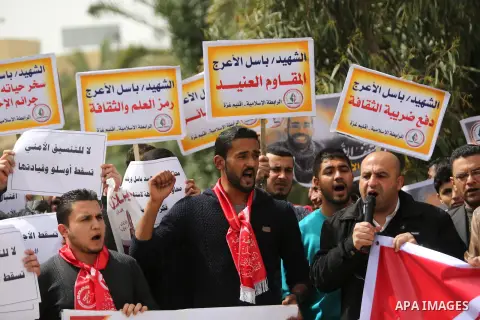 Palestinian supporters of the Popular Front for the Liberation of Palestine (PFLP), hold placards during a protest against the trial of the martyr, Bassel al-Aaraj, and the security coordination in Gaza City, on March 12...