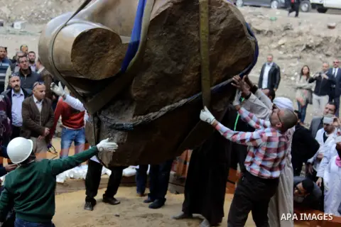 Egyptian workers excavate the statue, recently discovered by a team of German-Egyptian archeologists, in Cairo's Mattarya district on March 13, 2017. Statues of the kings and queens of the nineteenth dynasty (1295 - 1185...