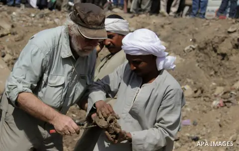 Egyptian workers excavate the statue, recently discovered by a team of German-Egyptian archeologists, in Cairo's Mattarya district on March 13, 2017. Statues of the kings and queens of the nineteenth dynasty (1295 - 1185...