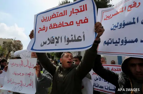 Palestinian factories owners demonstrate on March 13, 2017 outside the UN offices in Gaza City as their business were not yet rebuild since the 2014 war between Hamas militants and Israel. Photo by Ashraf Amra