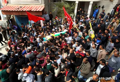 Mourners carry the body of Palestinian youth Morad Abu Ghazi, 16, who was killed by Israeli troops during clashes, during his funeral in al-Arroub refugee camp near the West Bank city of Hebron March 18, 2017. Photo by W...