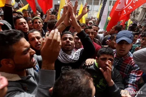 Mourners shout slogans during the funeral of Palestinian youth Morad Abu Ghazi,16, who was killed by Israeli troops during clashes, in al-Arroub refugee camp near the West Bank city of Hebron March 18, 2017. Photo by Wis...