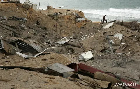 A Palestinian man walks past the scene of what Gaza police said was an Israeli air strike in Beit Lahia in the northern of Gaza Strip, on March 18, 2017. A rocket fired by Palestinians in the Gaza Strip slammed into sout...