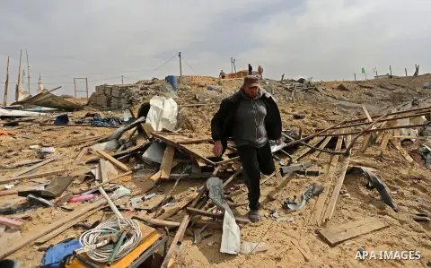 A Palestinian man walks past the scene of what Gaza police said was an Israeli air strike in Beit Lahia in the northern of Gaza Strip, on March 18, 2017. A rocket fired by Palestinians in the Gaza Strip slammed into sout...
