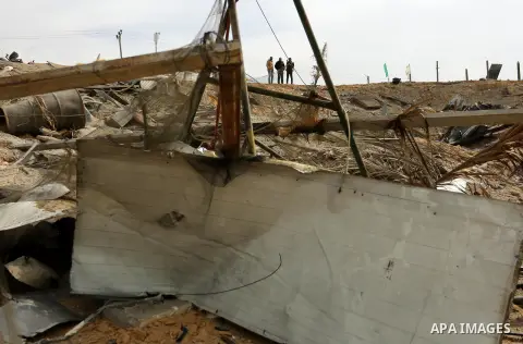 Palestinians inspect the scene of what Gaza police said was an Israeli air strike in Beit Lahia in the northern of Gaza Strip, on March 18, 2017. A rocket fired by Palestinians in the Gaza Strip slammed into southern Isr...