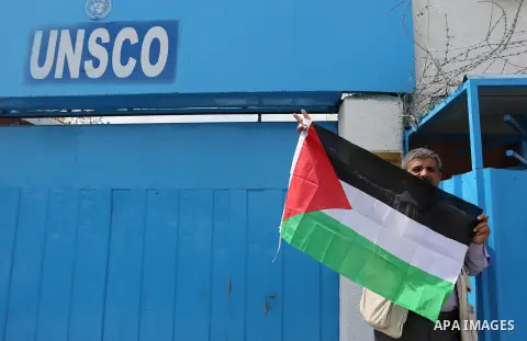 Palestinians hold banners during a protest against the U.N. Secretary-General Antonio Guterres decision to remove Israeli 'apartheid' report from Economic and Social Commission for Western Asia (ESCWA) website, in front...