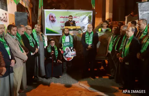 Palestinians take part in a memorial service marking the thirteenth anniversary of the death of late Hamas leader Sheikh Ahmed Yassin, who was killed in an Israeli attack in front of his house in Gaza City, March 21, 201...