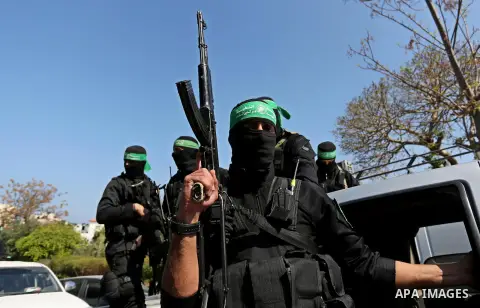 Members of the Ezzedine al-Qassam Brigades, the military wing of the Palestinian Islamist movement Hamas take part in the funeral of Hamas official, Mazen Faqha who was freed by Israel in a 2011 prisoner swap in Gaza Cit...