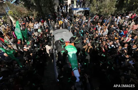 Members of the Ezzedine al-Qassam Brigades, the military wing of the Palestinian Islamist movement Hamas carry the body of Hamas official, Mazen Faqha who was freed by Israel in a 2011 prisoner swap during his funeral in...