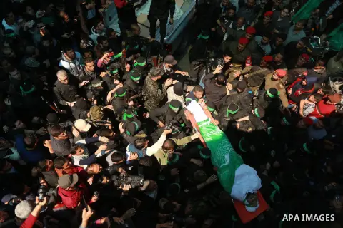 Members of the Ezzedine al-Qassam Brigades, the military wing of the Palestinian Islamist movement Hamas carry the body of Hamas official, Mazen Faqha who was freed by Israel in a 2011 prisoner swap during his funeral in...
