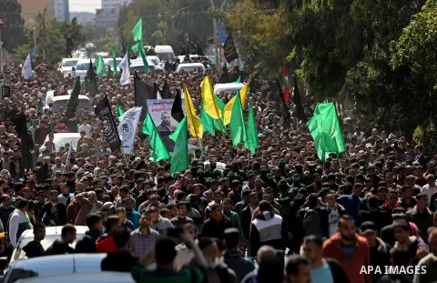 Members of the Ezzedine al-Qassam Brigades, the military wing of Hamas carry the body of Palestinian Islamist movement Hamas' official Mazen Faqha, during his funeral in Gaza city on March 25, 2017. Gunmen in the Gaza St...