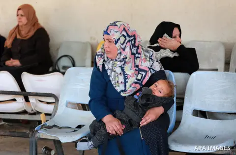 Palestinians wait at Erez border crossing into Israel, in Beit Hanun, in the northern Gaza Strip on March 26, 2017, after it was shut by the Islamist movement after blaming the Jewish state for the assassination of one o...