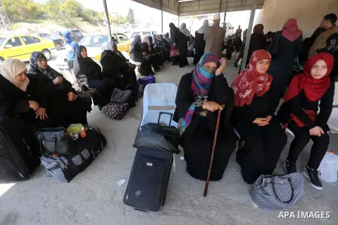 Palestinians wait at Erez border crossing into Israel, in Beit Hanun, in the northern Gaza Strip on March 26, 2017, after it was shut by the Islamist movement after blaming the Jewish state for the assassination of one o...