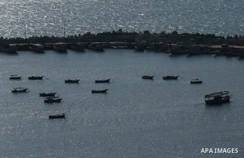 Palestinian fishermen ride their fishing boat at the beach of Gaza City on March 26, 2017, after the Islamist movement shut Erez border crossing and all borders, including its western sea border after blaming the Jewish...