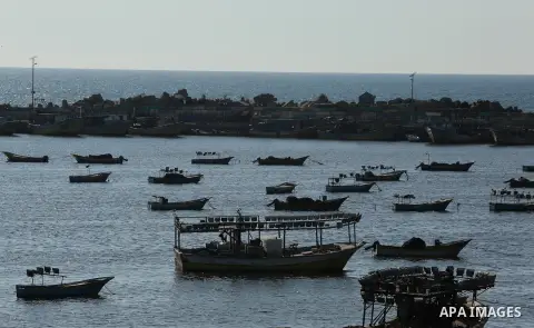 Palestinian fishermen ride their fishing boat at the beach of Gaza City on March 26, 2017, after the Islamist movement shut Erez border crossing and all borders, including its western sea border after blaming the Jewish...