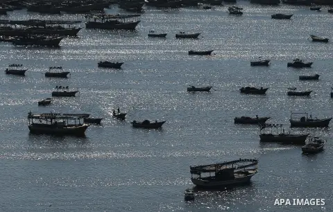 Palestinian fishermen ride their fishing boat at the beach of Gaza City on March 26, 2017, after the Islamist movement shut Erez border crossing and all borders, including its western sea border after blaming the Jewish...