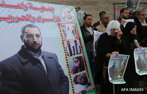 Palestinians take part during a protest denouncing an assassination of Hamas official, Mazen Faqha who was freed by Israel in a 2011 prisoner swap after he was shot dead by unknown gunmen, in front of Red cross office in...