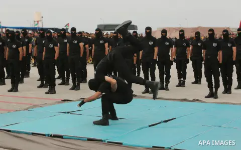 Palestinian police officers loyal to Hamas take part in a graduation ceremony in Gaza City March 30, 2017. Photo by Ashraf Amra