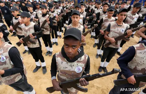 Palestinian high-school students show off their skills during a graduation ceremony from a military school course organised by the Palestinian security forces in Gaza strip, in Gaza City, on April 2, 2017. Photo by Ashra...