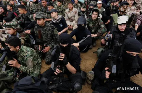 Palestinian high-school students show off their skills during a graduation ceremony from a military school course organised by the Palestinian security forces in Gaza strip, in Gaza City, on April 2, 2017. Photo by Ashra...