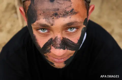 Palestinian high-school students show off their skills during a graduation ceremony from a military school course organised by the Palestinian security forces in Gaza strip, in Gaza City, on April 2, 2017. Photo by Ashra...