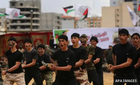 Palestinian high-school students show off their skills during a graduation ceremony from a military school course organised by the Palestinian security forces in Gaza strip, in Gaza City, on April 2, 2017. Photo by Ashra...