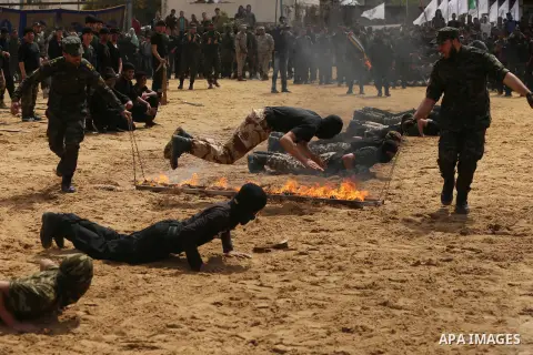 Palestinian high-school students show off their skills during a graduation ceremony from a military school course organised by the Palestinian security forces in Gaza strip, in Gaza City, on April 2, 2017. Photo by Ashra...