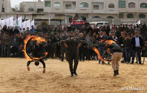 Palestinian high-school students show off their skills during a graduation ceremony from a military school course organised by the Palestinian security forces in Gaza strip, in Gaza City, on April 2, 2017. Photo by Ashra...