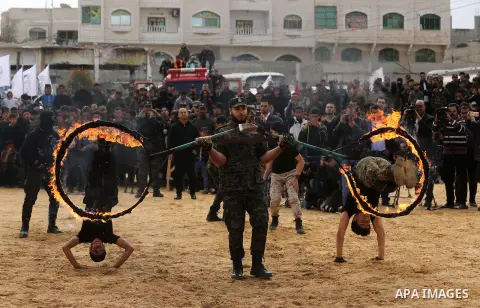 Palestinian high-school students show off their skills during a graduation ceremony from a military school course organised by the Palestinian security forces in Gaza strip, in Gaza City, on April 2, 2017. Photo by Ashra...